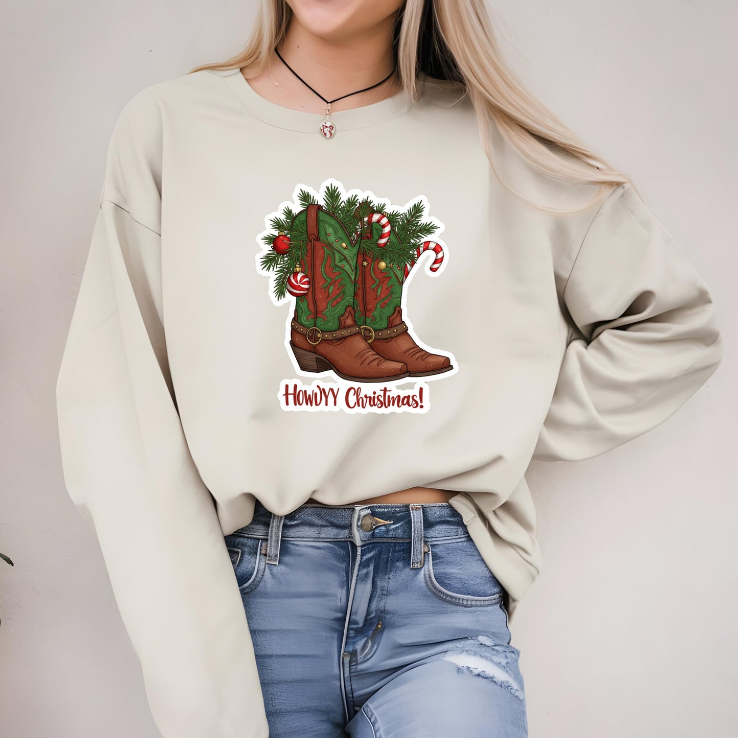 A woman wearing a white sweater with a graphic of a Christmas-themed boot on it.