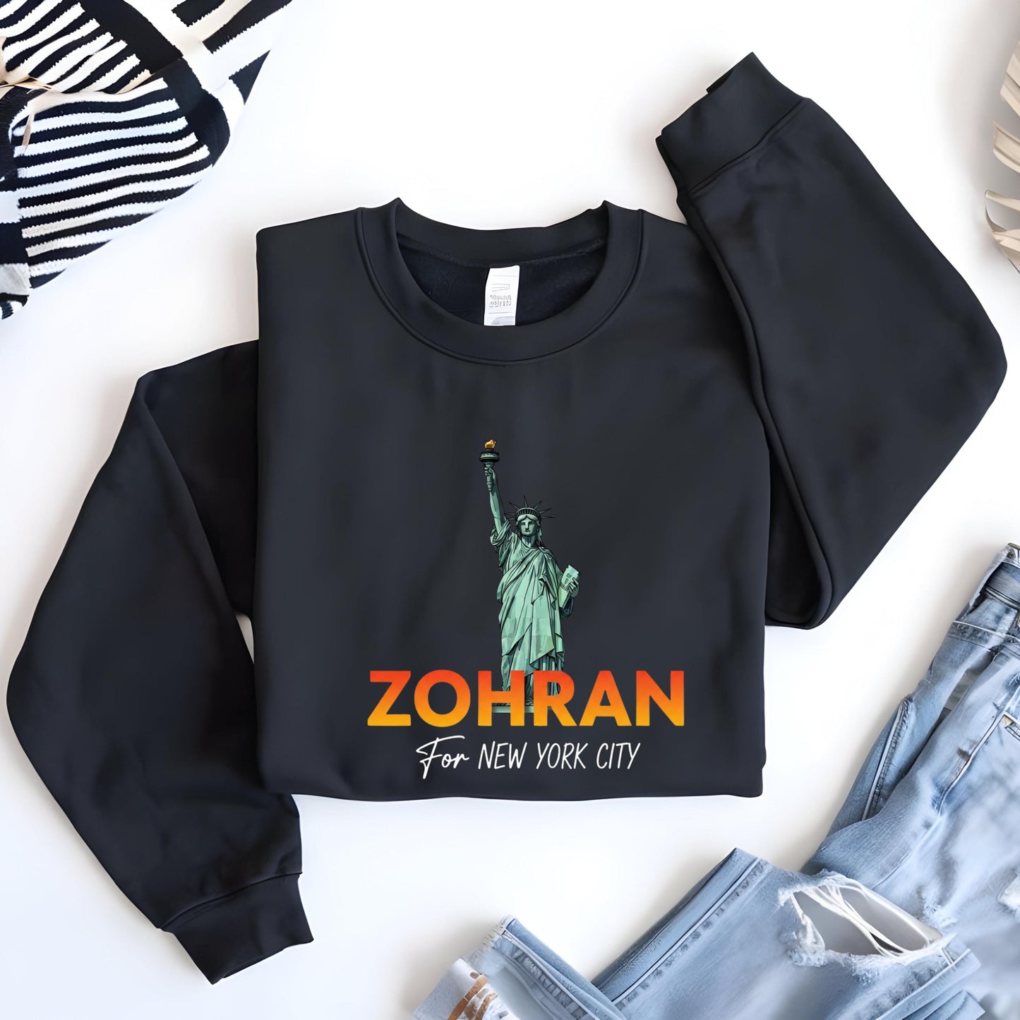 A black sweatshirt with a graphic of the Statue of Liberty and the text "ZOHRAN For New York City" printed on it.