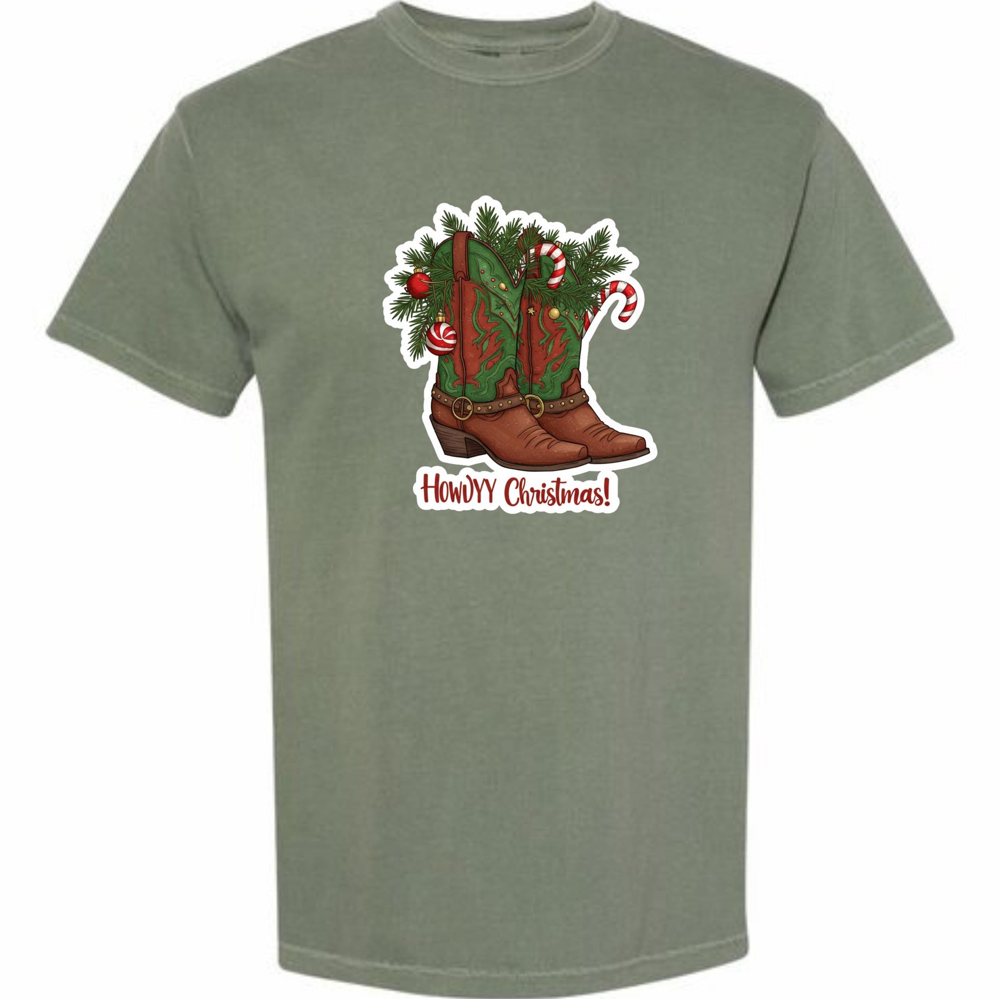 A t-shirt with a graphic design depicting a pair of brown cowboy boots adorned with Christmas decorations, including candy canes and pine branches. The text "Howdy Christmas!" is displayed below the boots.