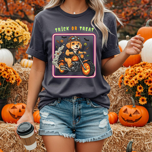 A woman wearing a t-shirt with a graphic of a dog riding a motorcycle, holding a coffee cup, and surrounded by pumpkins and flowers.