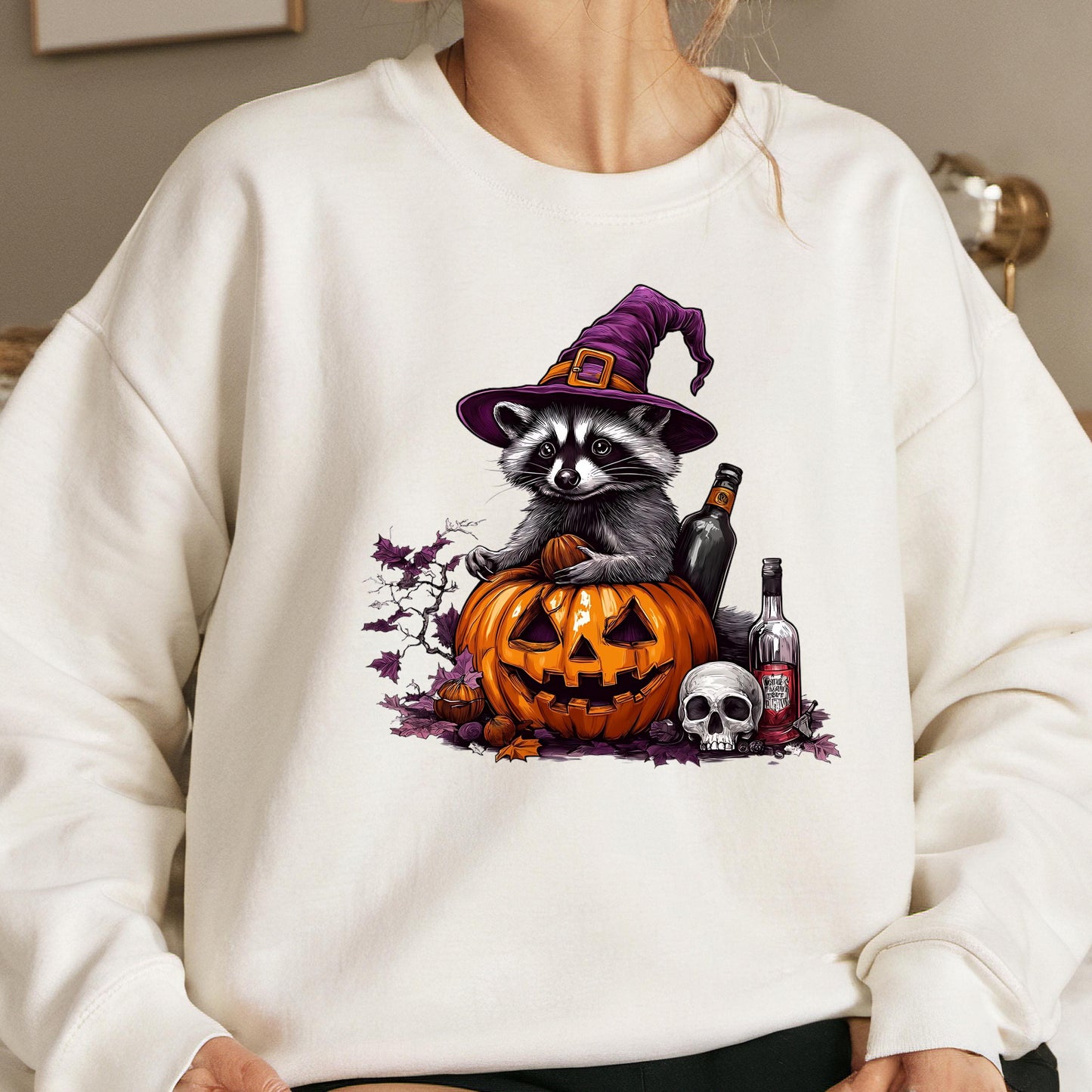 A raccoon wearing a witch's hat sits on a carved pumpkin, surrounded by Halloween-themed elements such as a skull, bottle, and bottle cap.