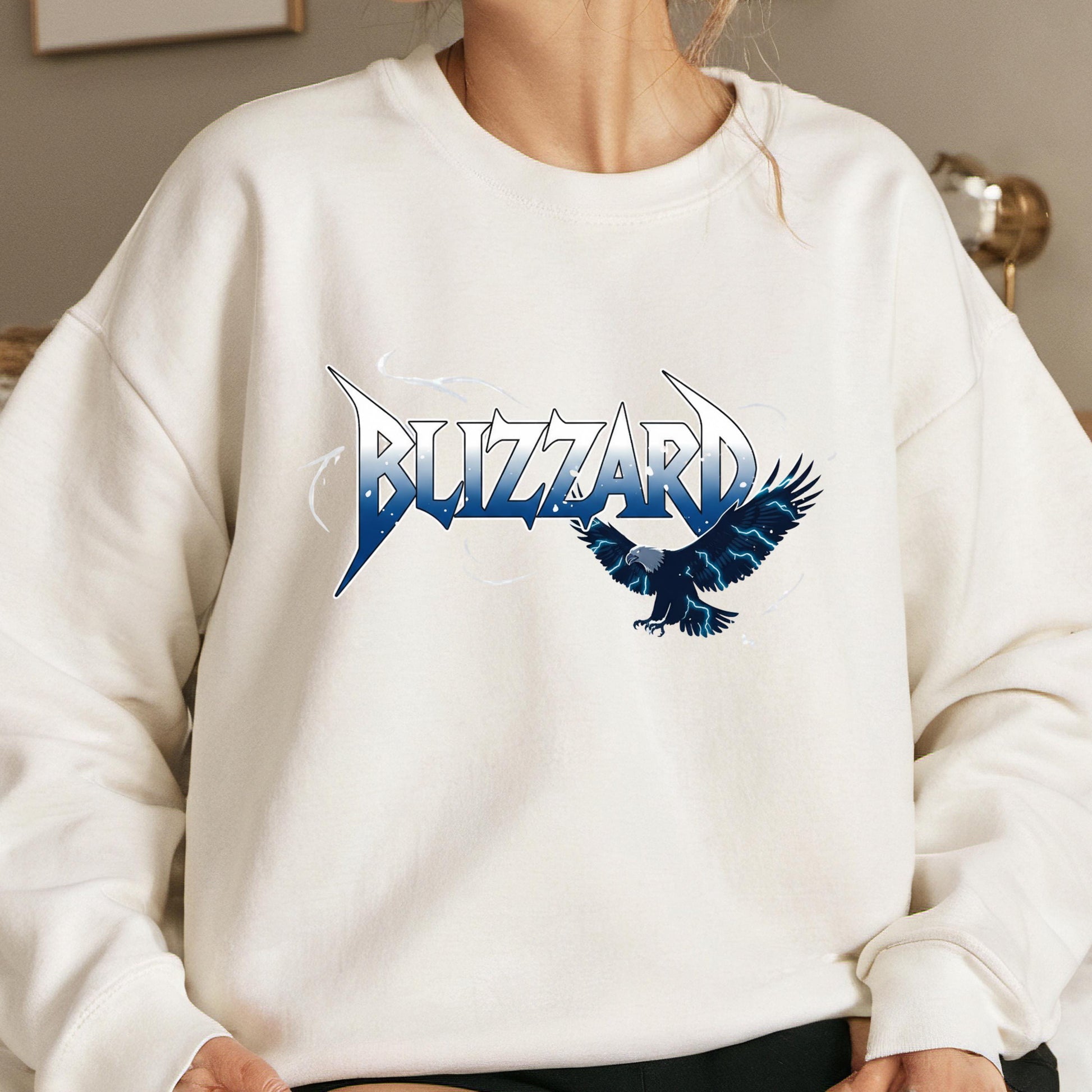 A white sweatshirt with a graphic design featuring the word "BUZZARD" and an image of a bird in flight.