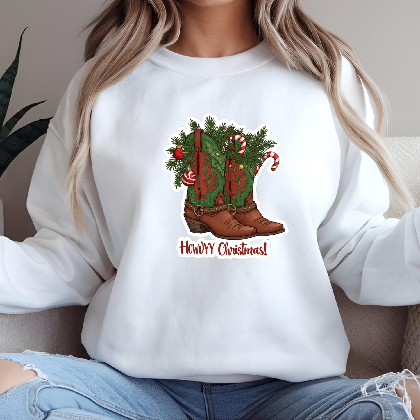 A woman wearing a white sweatshirt with a graphic of a Christmas boot on it.