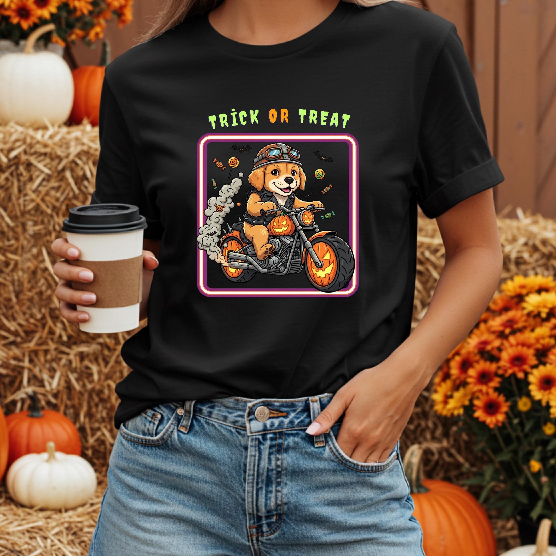A person wearing a black t-shirt with a graphic of a dog riding a motorcycle and the text "TRICK OR TREAT" printed on it.