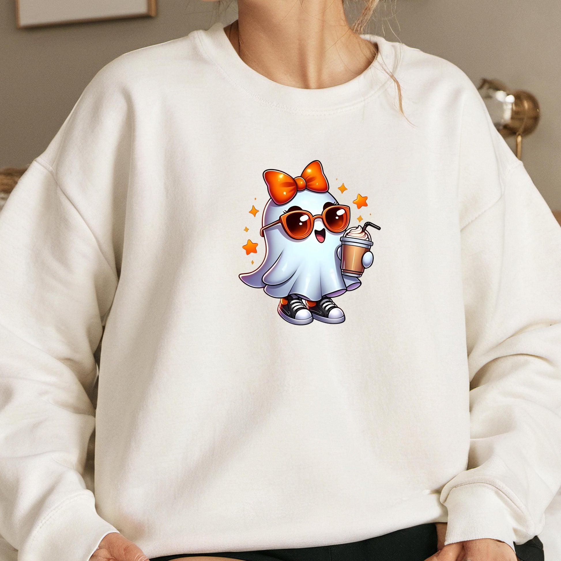 A white sweatshirt with a cartoon ghost character wearing sunglasses and holding a drink.