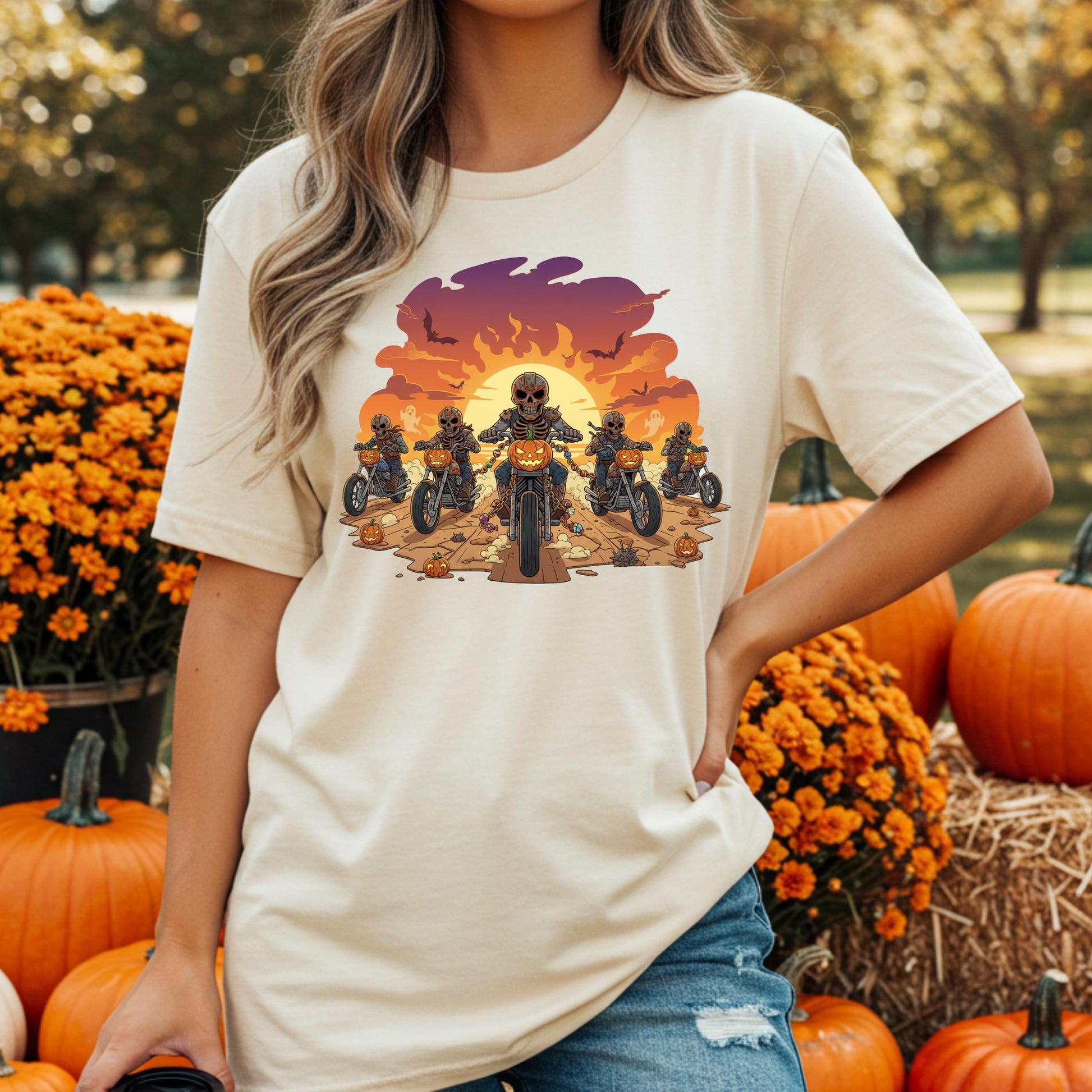 A woman wearing a white t-shirt with a graphic design of a group of people riding motorcycles against a sunset background.