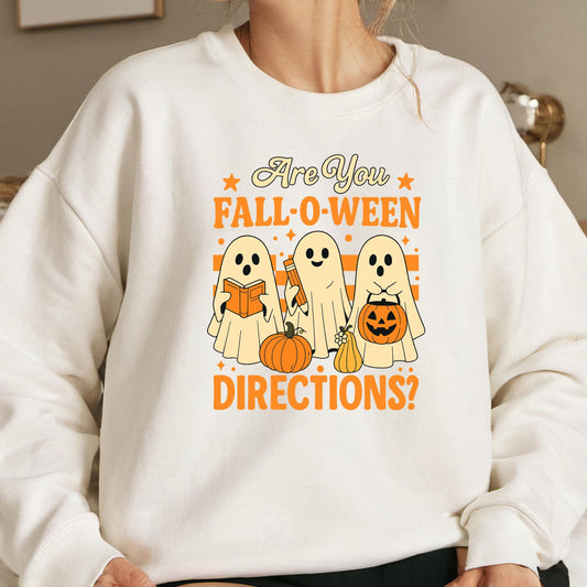 A white sweatshirt with a graphic design featuring three ghostly figures and Halloween-themed objects, along with the text &quot;Are You Fall-O-Ween Directions?&quot;