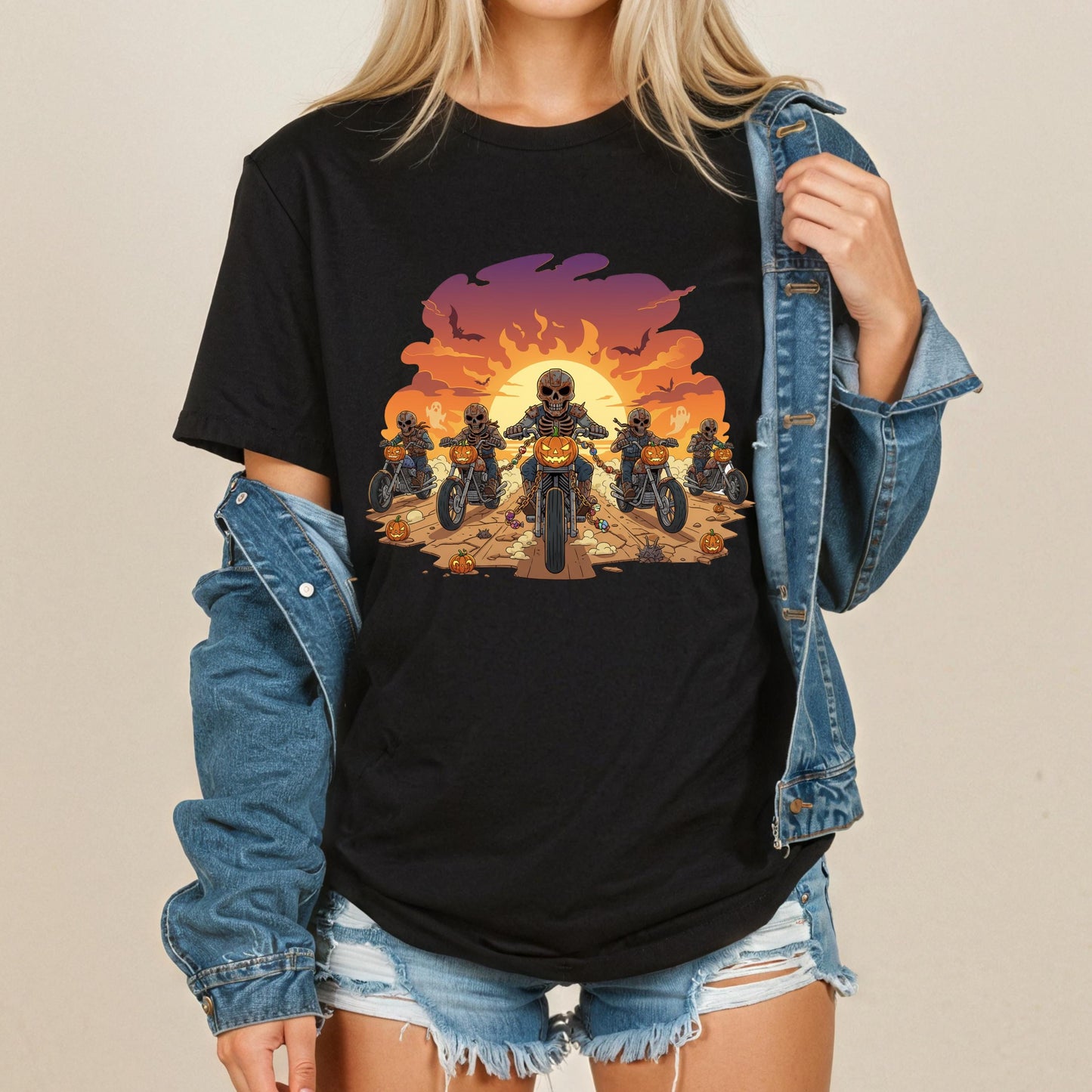 A woman wearing a black t-shirt with a graphic design of a group of people riding motorcycles against a sunset background.